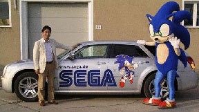 Sonic & Yuji Naka with a Sega Car