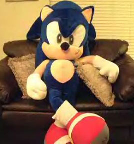 Relaxing giant Sonic plush on a chair
